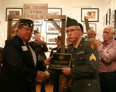Paul Whitfield, American Legion Commander, District 1 representing the Washington Generals presenting the plaque to Former Sargent Christopher Gaynor of Vashon Island, Curator of the VMIHA exhibit Home of Record: Vashon and the Vietnam War