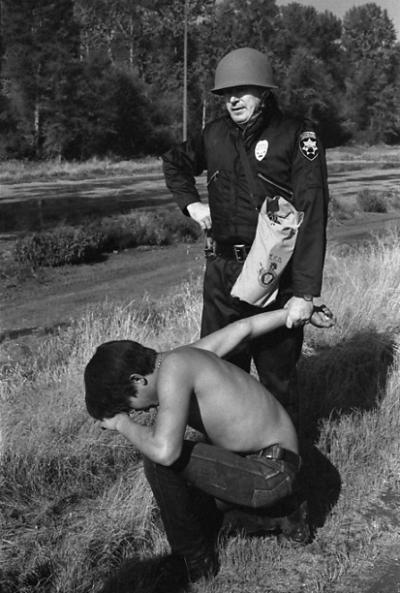 1970 Fishing Protest at Puyallup River, Tacoma. Police arrest a young tribal fisherman who appears to be suffering from exposure to tear gas.   Photos courtesy of the S. Lehmer & D. Fear collections at The Puyallup Tribe Historic Preservation Department