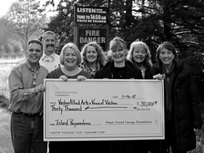 Left to right: Hans Herrmann and Patti McClements from the Puget Sound Energy community relations team. Assistant Chief for Operations at VIFR, George Brown (rear). VoV Board member Verna Everitt (rear), who manages the station’s grant program. VAA Board member Denise Katz. VoV Station Manager Susan McCabe (rear), VoV President Jean Bosch. Photo by Justin Huguet