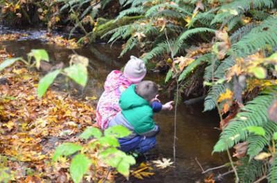 Mallory and Gavin Keenan, watching salmon last year at Judd Creek. Photo by Kelly Keenan