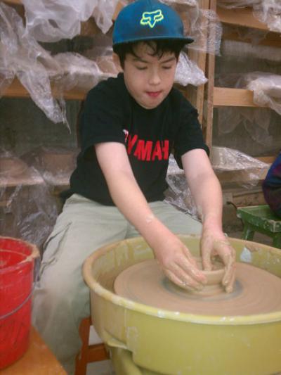 5th grader Lucca Shattuck at the pottery wheel